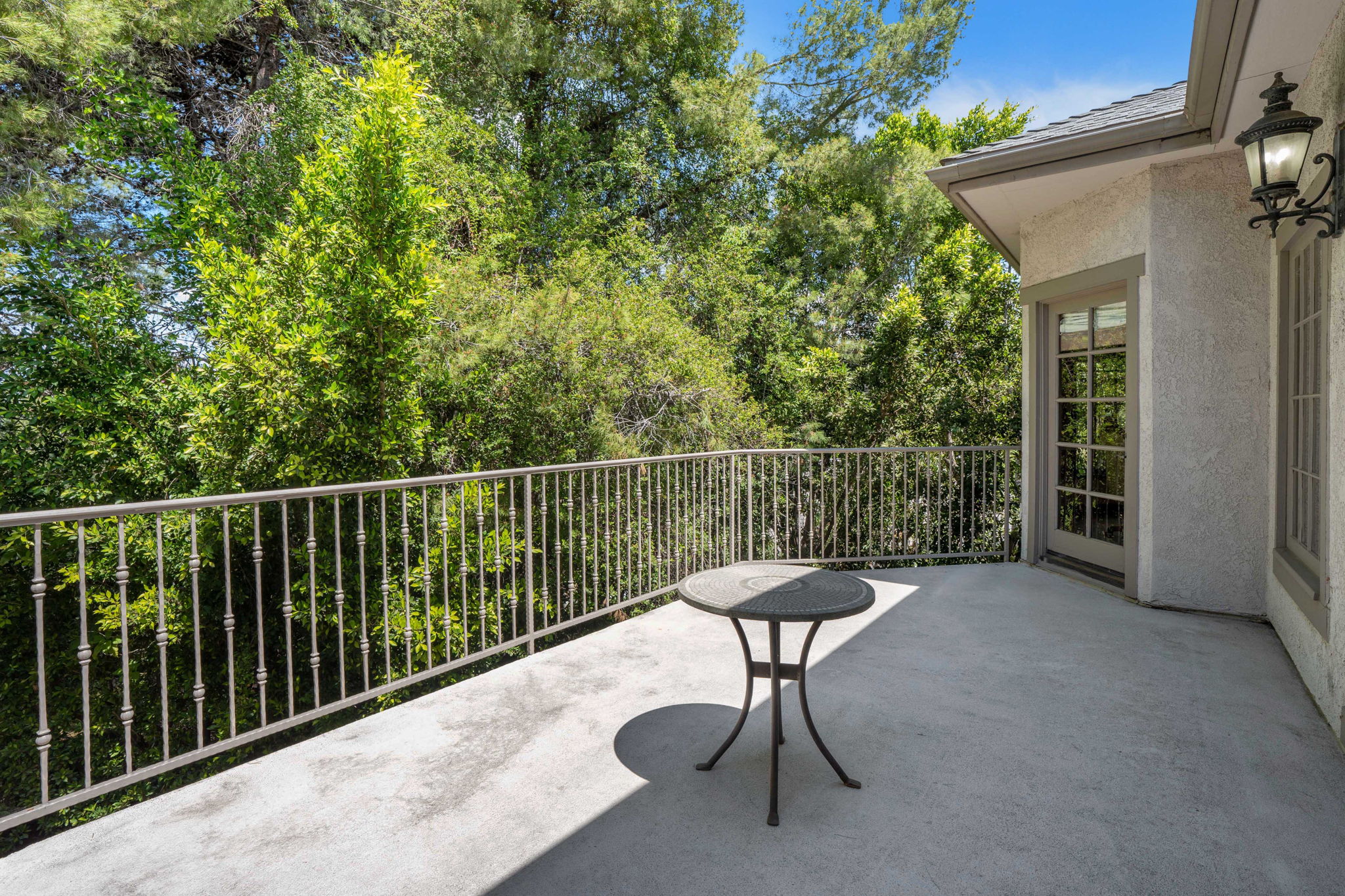 Balcony with a wooded tree-line view from Chelsea Manor