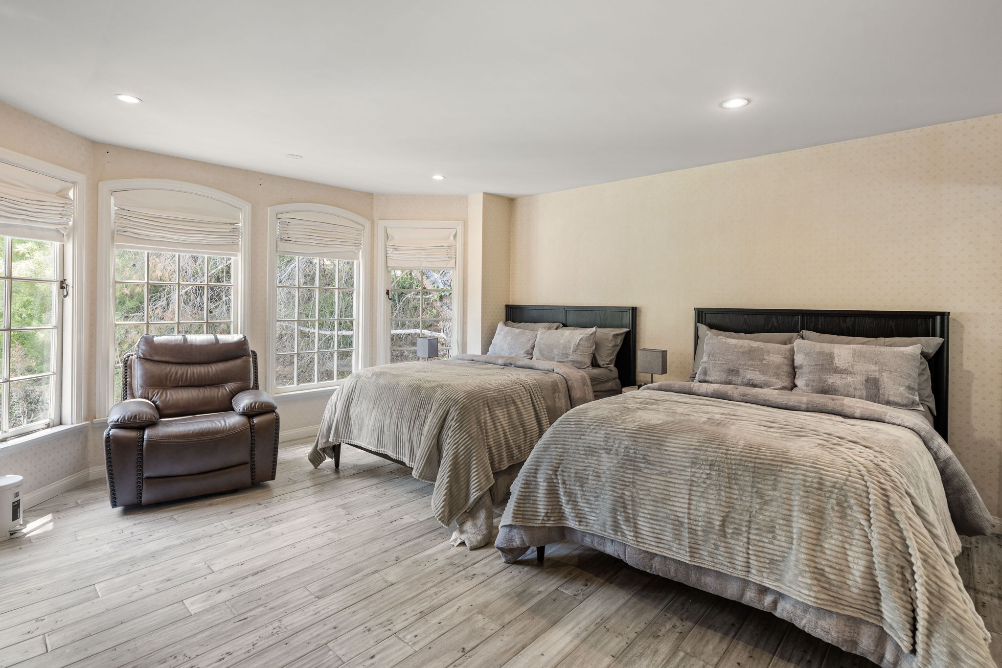 Twin bedroom suite with neutral tones and comfortable bedding