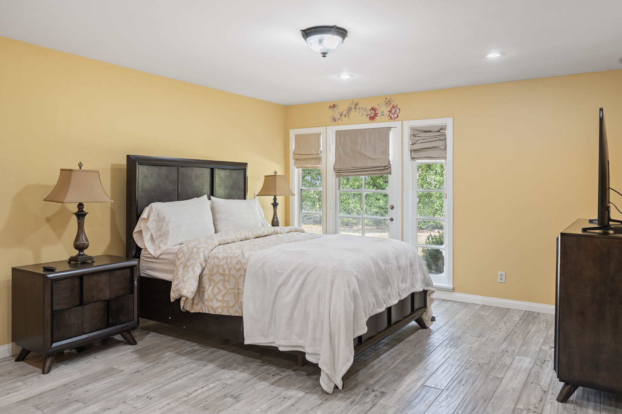 Bright king bedroom suite with garden-view windows