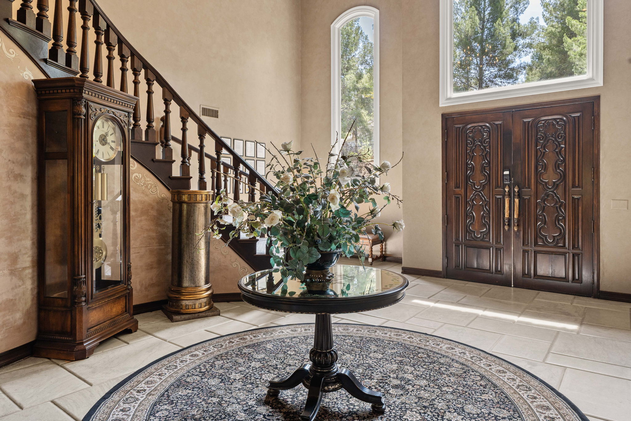 Grand entry foyer with ornately carved wooden doors