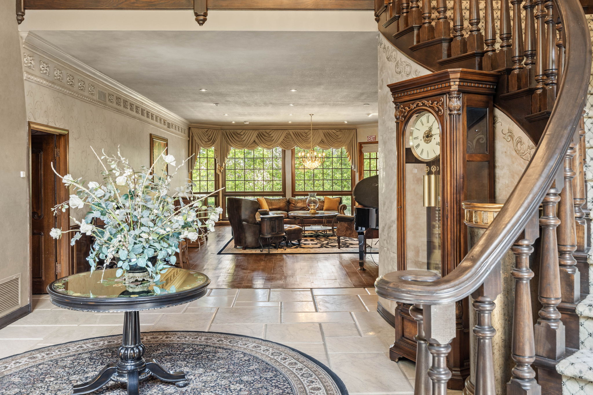 Foyer entrance featuring a grand piano and soaring ceilings