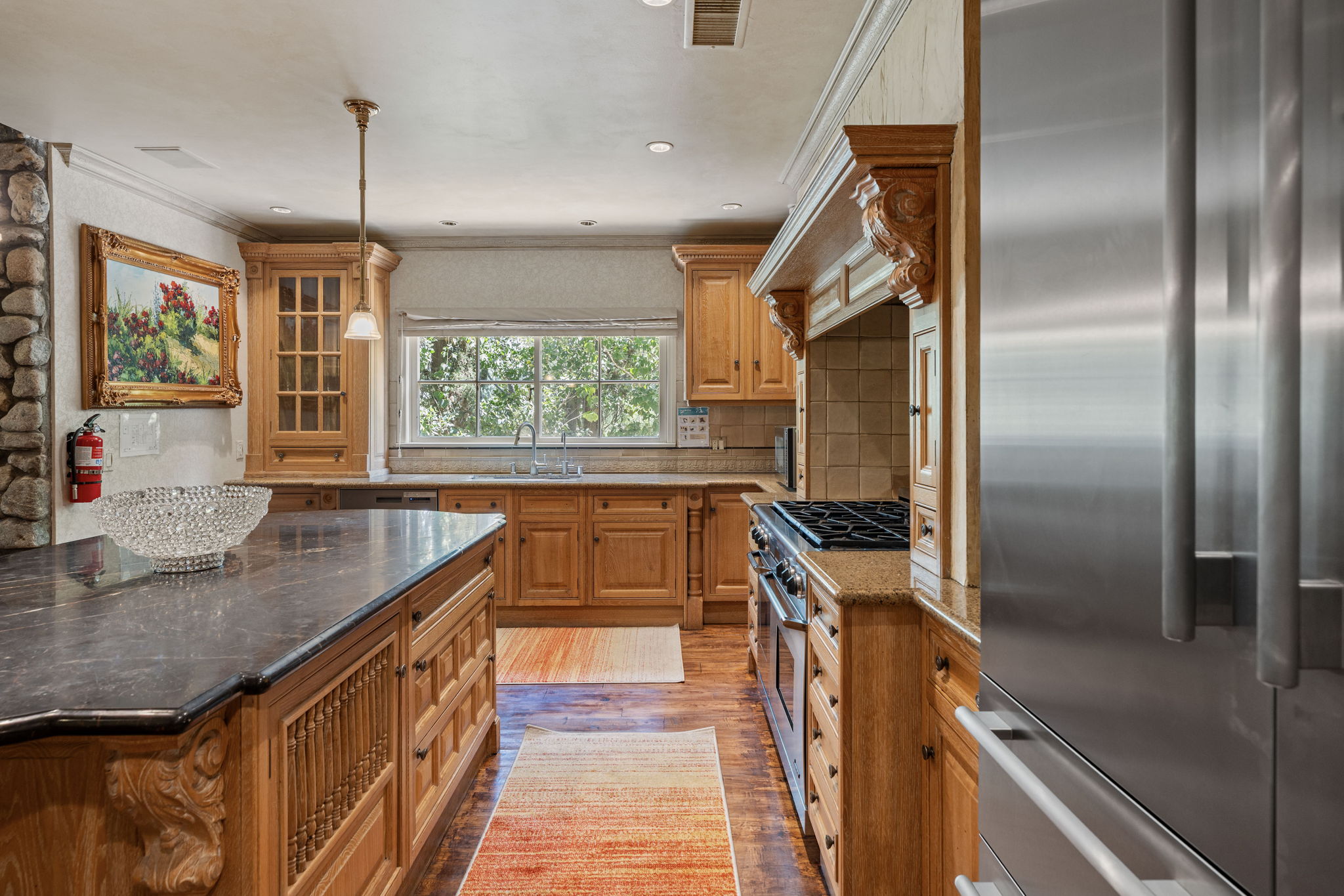 Professional kitchen with large center island and premium appliances