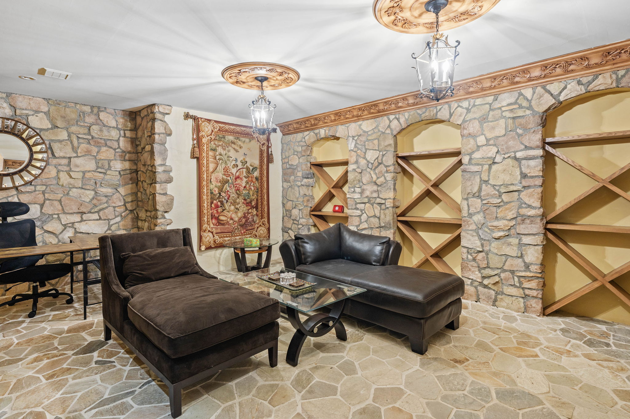 Study room with stone fireplace and chaise lounge seating