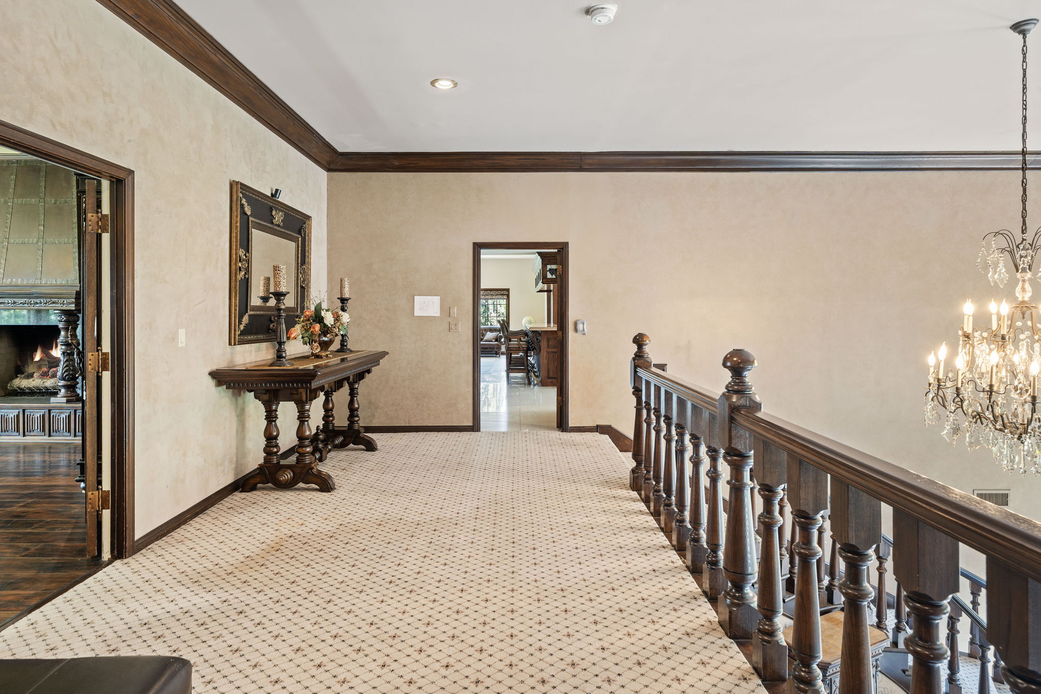 Upper landing with ornate banister overlooking the foyer below